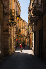 Obraz premium Charming historic streets and architecture of Taranto old town (Citta Vecchia) in Puglia, Italy. Featuring ancient stone buildings, narrow alleys, and rich heritage.