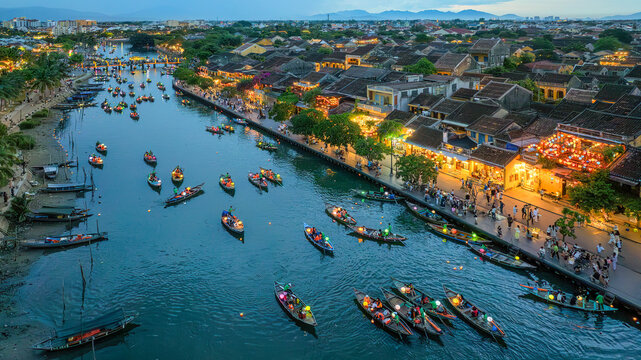Hoi An ancient town which is a very famous destination for tourists. tourists from Thailand, Korea, America and Japan are relax and experiencing a basket boat tour