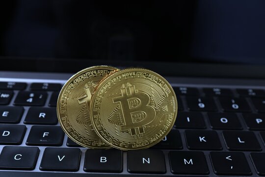 Cryptocurrency. Golden bitcoins on laptop, close-up. Banner tamplate