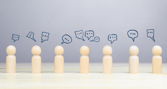 Concept of social networking, customer feedback, and brainstorming with wooden people