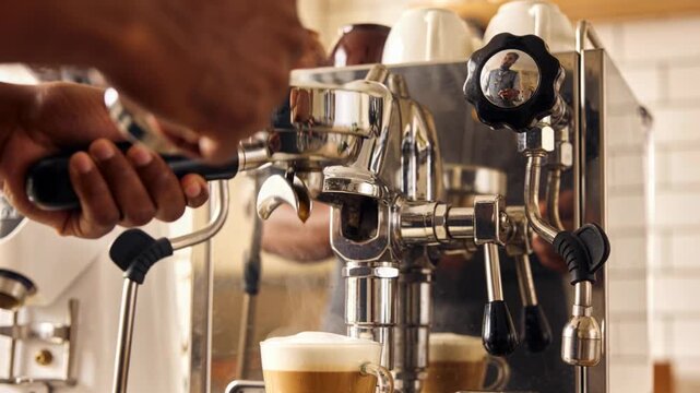 Tamping tamper into portafilter, hands locking head and pulling espresso into cup with frothed milk