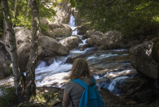 Woman looking at Moli del Salt waterfall in Lles, Cerdanya