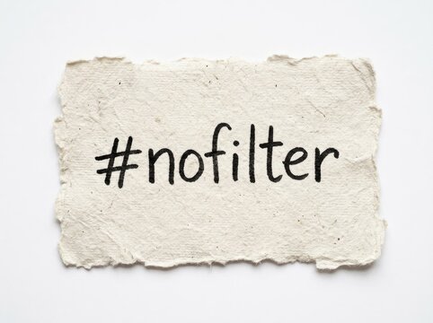 Handwritten hashtag nofilter on torn textured paper, social media Concept authentic communication and genuine expression online