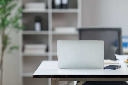Minimalist office workspace with a closed laptop and smartphone, representing modern productivity, remote work, digital communication, and business technology in a professional setting
