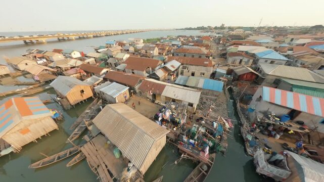 FPV aerial view of a slum with houses built on top of them in Makoko, Lagos, Nigeria