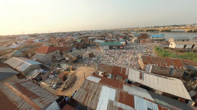 Houses built in a slum with people paddling canoes in Makoko, Lagos, Nigeria