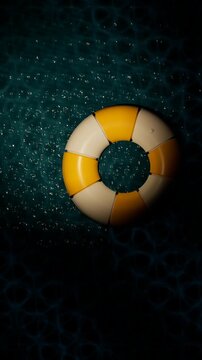 Lifesaver floating on dark water with bubbles. 3d rendering