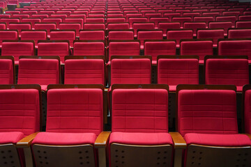 Naklejka premium Empty comfortable red seats with numbers in cinema