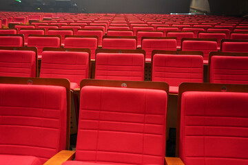 Fototapeta premium Empty comfortable red seats with numbers in cinema