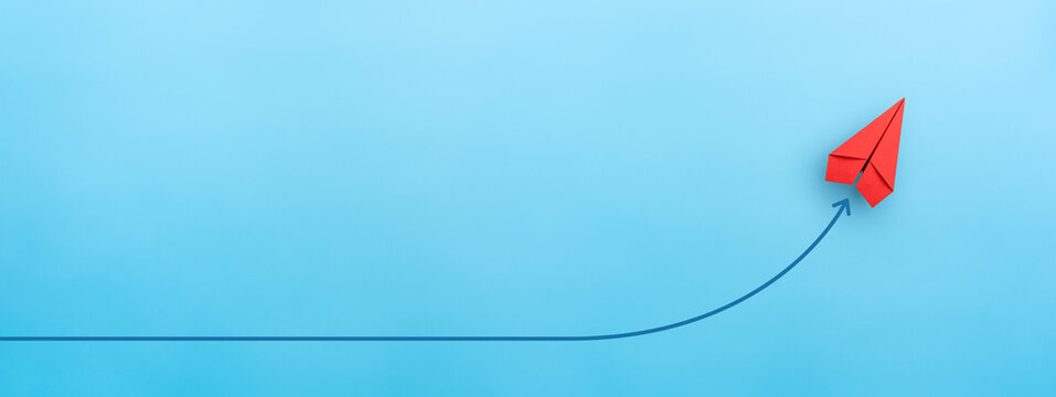 Red paper plane on blue background, Success in business growth concept. copy space
