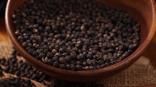 Black Peppercorns in a Wooden Bowl