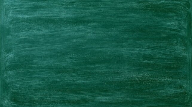 Empty green chalkboard texture with chalk smudges, blank blackboard background for education design.