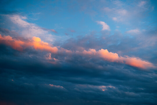 Vibrant sunset clouds creating a colorful atmospheric sky background. Nature, weather, inspiration and design concept with ample copy space.