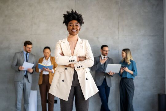 Professional in office environment, highlighting teamwork, collaboration, leadership, and innovation