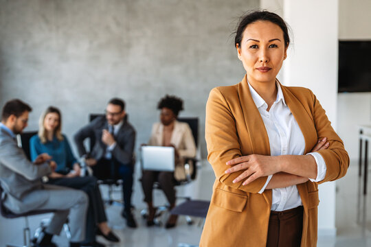 Young happy successful business woman working in corporate office