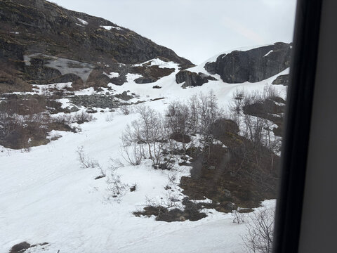a view of the mountains from a train window