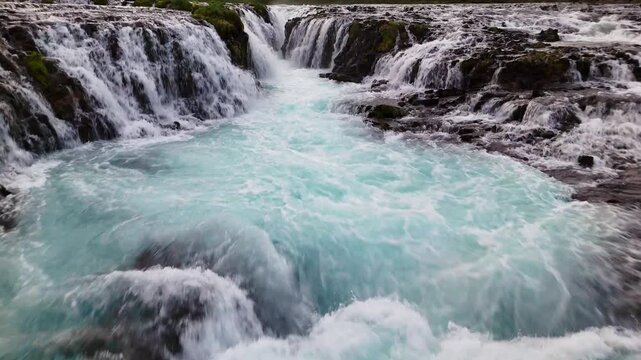Drone flies over Bruarfoss main drop toward downstream river transition for travel docs, Iceland