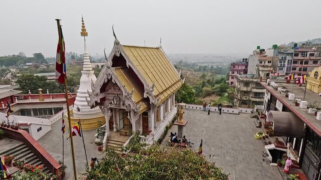 Nagar Mandap Shree Kirti Bihar Thai Buddhist temple wide shot, gold roof and white stupa, Buddhist flags, Kirtipur, Nepal