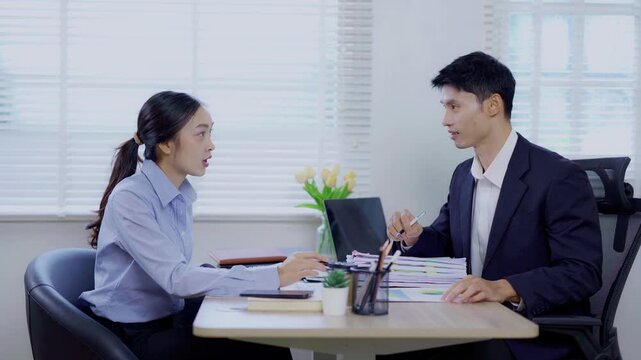 Two Asian businesswomen shaking hands with colleague. Two professional business owners shaking hands to agree to work together in an organization.	
