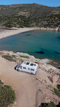 Experience the beauty of Milos Island in Greece with its breathtaking coastal landscapes, pristine beaches, and a cozy campervan parked near the crystal-clear waters of the Cyclades