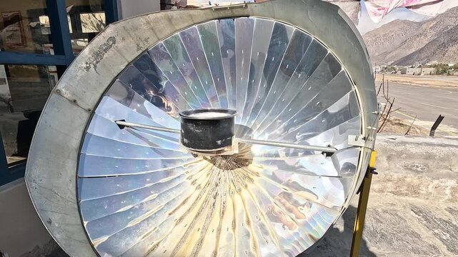 Parabolic solar cooker reflector dish pot rooftop Jomsom Mustang Nepal Himalaya village
