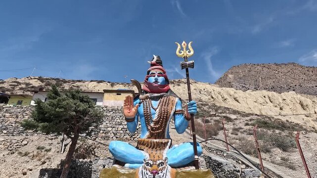 Blue Shiva statue trident tiger throne shrine Jomsom Mustang Nepal Hindu religious site
