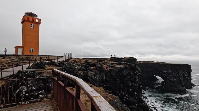 Viewing platform and wooden railing at Svortuloft cliffs, natural rock arch and Atlantic coast, Snaefellsnes