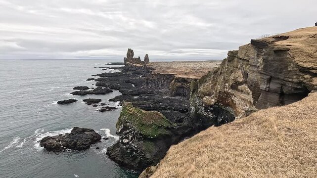 L&Atilde;&sup3;ndrangar twin basalt sea stacks rising from jagged coastal cliffs, Atlantic Ocean, Snaefellsnes, Iceland