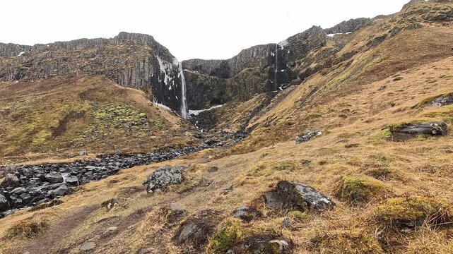 Wide view of Kerlingarfoss waterfall dropping through basalt gorge with stream, Snaefellsnes Peninsula, Iceland
