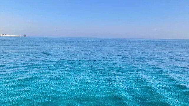A view of the turquoise waters of the Mediterranean Sea off the coast of Cyprus, under a clear blue sky and calm waves. Marine video wallpaper