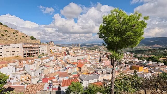 Jaen city panorama from Mirador del Tambor, white rooftops and cathedral towers above olive groves, Andalusia, Spain