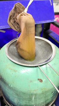 Professional car heater system cleaning process uses special filter bag over metal strainer on fluid tank. Maintenance service, cleaning liquid is used. for improves heating efficiency, vertical