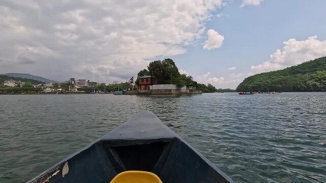 Doonga boat POV approaching Tal Barahi island temple on Phewa Lake, Pokhara, Nepal
