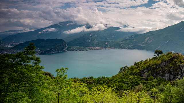 Panoramic nature landscape overlooking the cam Garda lake nestled in lush forests, ideal for tourism exploration, Arco, Trentino, Veneto, Italy.