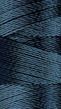 Blue Twisted Fiber Texture. Macro view of layered dark blue strands forming a dense abstract pattern with smooth camera movement.
