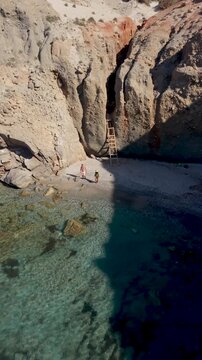 Discover the breathtaking beauty of Milos in Greece, featuring pristine beaches nestled among dramatic cliffs. Enjoy swimming in the turquoise waters at Tsigrado Beach