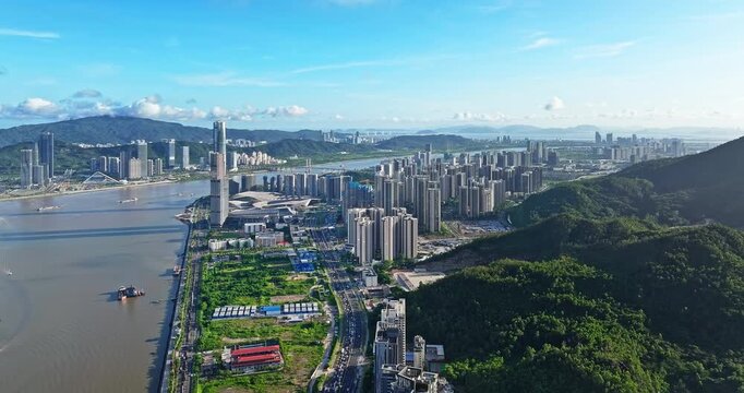 Aerial view of a modern city skyline and waterfront development in Zhuhai, China