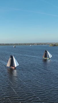 Traditional sailing skutsjes sailing in Friesland Netherlands