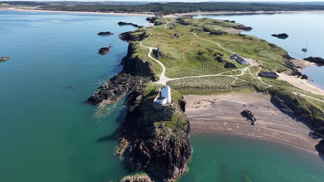 Drone from LLanddwynn lighthouse, Anglesey rising out to sea