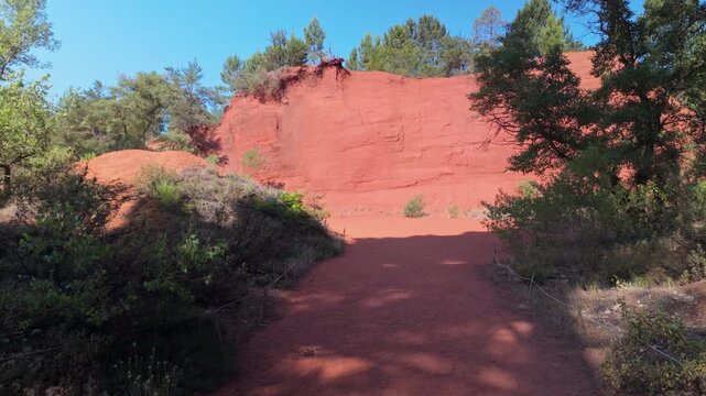 Colorful sand and rocks in the Colorado Provencal, a spectacular semi-natural landscape of ancient ochre quarries located next to the village of Rustrel, France. Upwards motion.