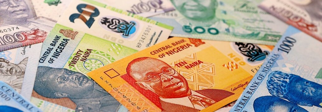 Nigeria naira money bills pile on table. Nigeria banknotes of NGN currency close up.