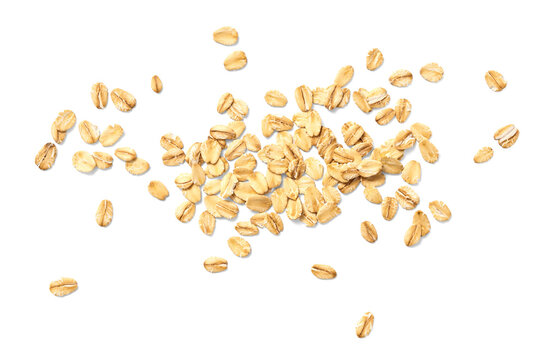 Scattered oat flakes on a clean white background.  Top view of oat flakes isolated.