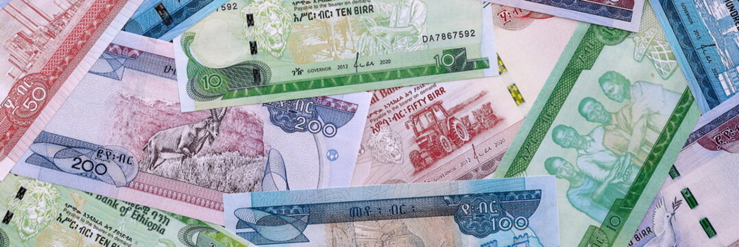 Ethiopian birr money bills pile on table. Ethiopia banknotes of ETB currency close up.