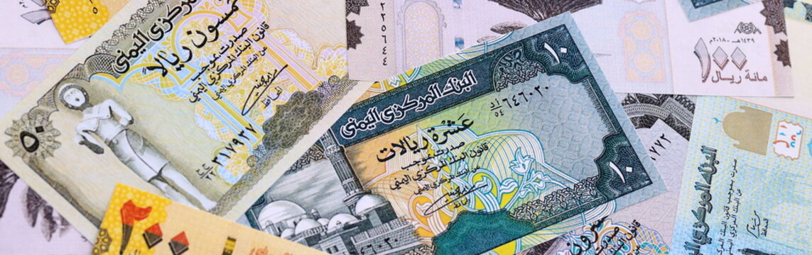 Yemeni rial money bills pile on table. Yemen banknotes of YER currency close up.