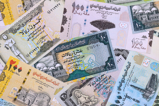 Yemeni rial money bills pile on table. Yemen banknotes of YER currency close up.