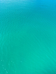 Obraz premium Water covers a large area in bright blue color during a sunny day near a coastal location
