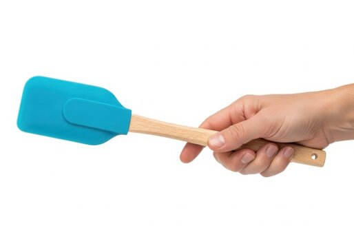 Hand holding bright blue silicone spatula isolated on white background