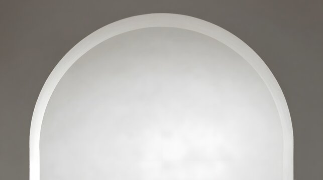 Closeup of a white semicircle object with a smooth curved edge and a bright shiny center on a gray background