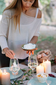 Woman preparing a romantic candlelight meal outdoors