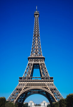 Low angle view of the Eiffel Tower in Paris against a blue sky